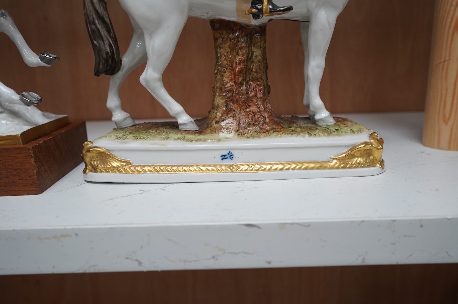 A group of three continental porcelain models of riders on horseback, tallest 27cm